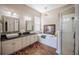 Main bathroom features double sinks, large soaking tub and a separate glass enclosed shower at 7104 Lake Eaglebrooke Way, Lakeland, FL 33813