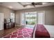 Main bedroom features ceiling fan, wood floors, view of the screened patio and the beautiful lake beyond at 7104 Lake Eaglebrooke Way, Lakeland, FL 33813