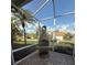 View of the back yard through screened patio area with a brick floor and outdoor grill at 7104 Lake Eaglebrooke Way, Lakeland, FL 33813