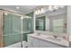 Bright bathroom featuring a double vanity and a shower with eye-catching green hexagon tiles at 7187 Cruz Ct, Lakeland, FL 33813