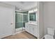 Bathroom with double sink vanity and tiled shower with glass doors at 7187 Cruz Ct, Lakeland, FL 33813