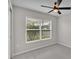 Neutral bedroom features large window and carpeted floors, and a ceiling fan at 7187 Cruz Ct, Lakeland, FL 33813