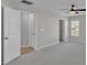 Neutral bedroom featuring a ceiling fan, carpeted floor and two closets at 7187 Cruz Ct, Lakeland, FL 33813