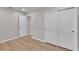 Bedroom featuring light wood floors, a closet with sliding doors, and neutral walls at 7187 Cruz Ct, Lakeland, FL 33813