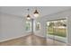 Bright room with light wood flooring, pendant lighting, and sliding glass doors to the outdoors at 7187 Cruz Ct, Lakeland, FL 33813