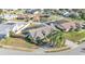 Drone image of a home with a well-maintained lawn and landscaping in a suburban neighborhood at 7321 Gunstock Dr, Lakeland, FL 33809