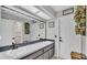 Bright bathroom with dual sinks, neutral cabinets, and a large mirror at 7321 Gunstock Dr, Lakeland, FL 33809