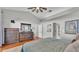 Bright bedroom with a dresser, ceiling fan and natural light at 7321 Gunstock Dr, Lakeland, FL 33809