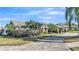 A well-kept front yard and driveway lead up to the home, surrounded by lush, tropical landscaping at 7321 Gunstock Dr, Lakeland, FL 33809