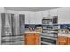 Close-up of the kitchen with stainless steel appliances, modern cabinetry, and a blue tiled backsplash at 7321 Gunstock Dr, Lakeland, FL 33809