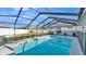 Backyard fenced in pool with screened in enclosure and lounge chair on patio at 7321 Gunstock Dr, Lakeland, FL 33809