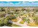 Aerial view of a residential street featuring landscaped yards and mature trees in a well-kept neighborhood at 7997 Kaitlin Cir, Lakeland, FL 33810