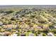 Aerial view of a home with a backyard pool, covered patio, and fenced yard in a residential neighborhood at 7997 Kaitlin Cir, Lakeland, FL 33810