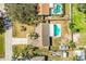 An aerial view of a home featuring a backyard pool, patio area, and mature landscaping at 7997 Kaitlin Cir, Lakeland, FL 33810