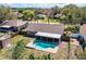 Aerial shot of a backyard with a private pool, covered patio, and lush landscaping, perfect for outdoor living at 7997 Kaitlin Cir, Lakeland, FL 33810