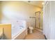 Spacious bathroom featuring soaking tub, walk-in shower, and linen closet at 7997 Kaitlin Cir, Lakeland, FL 33810