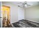 This bedroom features wood-look flooring, a ceiling fan, and a closet with bi-fold doors at 7997 Kaitlin Cir, Lakeland, FL 33810