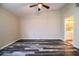 Large bedroom featuring modern floors, ceiling fan, and ensuite bathroom at 7997 Kaitlin Cir, Lakeland, FL 33810