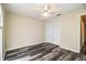 Cozy bedroom featuring stylish floors, a ceiling fan, and a closet for ample storage at 7997 Kaitlin Cir, Lakeland, FL 33810