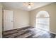 Comfortable bedroom showcasing wood-look floors, neutral walls, a ceiling fan, and a bright window at 7997 Kaitlin Cir, Lakeland, FL 33810