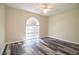 Bright bedroom with wood-look floors, neutral walls, ceiling fan, and a window providing natural light at 7997 Kaitlin Cir, Lakeland, FL 33810