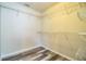 Walk-in closet offers ample shelving space and laminate wood-look flooring at 7997 Kaitlin Cir, Lakeland, FL 33810