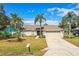 Charming single Gathering home showcasing manicured lawn and mature palm trees at 7997 Kaitlin Cir, Lakeland, FL 33810