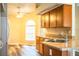 A cozy kitchen showcasing stainless steel sink, natural light and hardwood cabinets at 7997 Kaitlin Cir, Lakeland, FL 33810