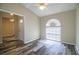 Living room with window and laminate flooring; neutral walls and white trim at 7997 Kaitlin Cir, Lakeland, FL 33810