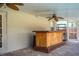 Outdoor covered bar area with ceiling fans and wood bar at 7997 Kaitlin Cir, Lakeland, FL 33810