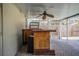 Covered outdoor bar area with wood bar and view of fenced yard at 7997 Kaitlin Cir, Lakeland, FL 33810