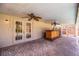 Inviting covered patio featuring a built-in bar, ceiling fans, and brick flooring perfect for outdoor entertaining at 7997 Kaitlin Cir, Lakeland, FL 33810