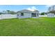 Spacious backyard featuring lush green lawn, secure fencing, and a storage shed at 8350 Split Creek Cir, Lakeland, FL 33809