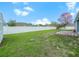 Spacious backyard features lush green lawn, white fence, and a blossoming pink tree at 8350 Split Creek Cir, Lakeland, FL 33809