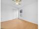 Inviting bedroom featuring hardwood floors, ceiling fan, and a bright window at 8350 Split Creek Cir, Lakeland, FL 33809