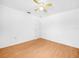 Well-lit bedroom featuring hardwood floors, ceiling fan, and a bright window at 8350 Split Creek Cir, Lakeland, FL 33809