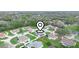 Aerial view of a residential community, featuring tree-lined streets and a mix of home styles at 8350 Split Creek Cir, Lakeland, FL 33809