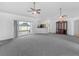 Bright living room with open floor plan, ceiling fans, and sliding door access to the outdoor area at 8350 Split Creek Cir, Lakeland, FL 33809