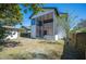 Home's backyard featuring a spacious sunroom with a spiral staircase and a detached garage at 949 Success Ave, Lakeland, FL 33801