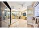 Spacious bathroom featuring mirrored wall, glass block window, and light tile flooring at 949 Success Ave, Lakeland, FL 33801