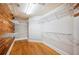 Walk-in closet with wood floors and white shelving offering ample storage space at 949 Success Ave, Lakeland, FL 33801