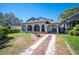 Charming home with unique architecture, covered carport, and manicured lawn at 949 Success Ave, Lakeland, FL 33801