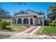 Charming home featuring arched windows, a brick driveway, and a welcoming front yard at 949 Success Ave, Lakeland, FL 33801