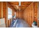 Unfinished garage interior featuring natural wood studs and rafters and dual windows at 949 Success Ave, Lakeland, FL 33801