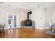 Bright living room featuring a unique fireplace, hardwood floors, and double glass doors for natural light at 949 Success Ave, Lakeland, FL 33801