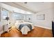 This main bedroom features hardwood floors, multiple windows, and a ceiling fan at 949 Success Ave, Lakeland, FL 33801