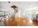 Open layout featuring a spiral staircase, hardwood floors, and views into the kitchen at 949 Success Ave, Lakeland, FL 33801