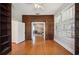 Well-lit study featuring built-in wood bookcases and hardwood floors at 949 Success Ave, Lakeland, FL 33801