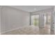 A light-filled living room with tile flooring and sliding glass doors leading to the outdoors at 965 Eagle Rock Ter, Winter Haven, FL 33880