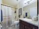 Clean bathroom with double sinks, shower-tub, and modern fixtures at 1134 Legatto Loop, Dundee, FL 33838
